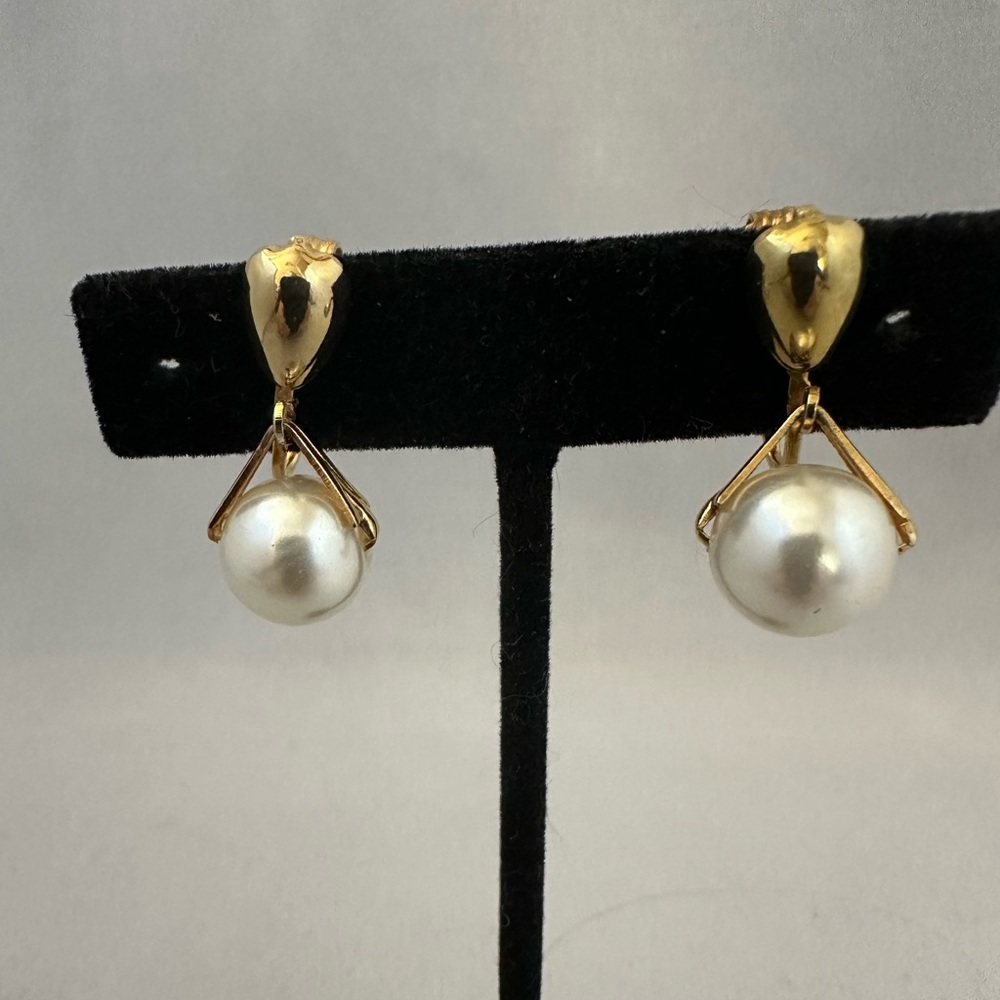 Gold tone clip earrings with faux pearl dangle